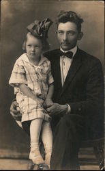 Man with young girl with big bow in hair portrait Postcard