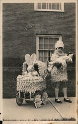 Stuffed bunny in decorated baby buggy with girl and tall doll Children Postcard Postcard Postcard