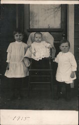 Three children posing on porch Postcard