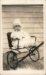 Baby in two wheeled cart Postcard