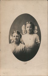 Two young girls with large bows in hair Postcard