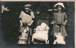 Two girls, baby in stroller, two doll strollers Postcard