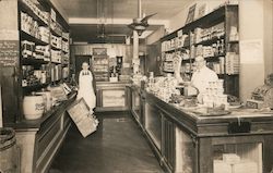 View inside grocery store with two male clerks Buildings Postcard Postcard Postcard