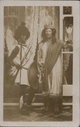 Two people in costumes: robe and crown, spears and shield Postcard