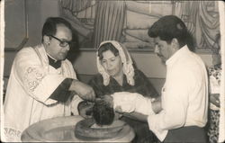 Baptism of child at baptismal font by priest Postcard