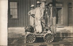 Four men on railroad handcart Postcard