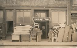 M.E. Moore Furniture with goods on street Postcard