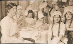 Young women in caps and braids at a party Postcard