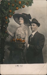 Colorized Studio photo couple picking oranges Postcard