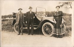 Two Men and a Woman Standing in Front of Car Cars Postcard Postcard Postcard