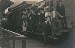 Group of men and women standing on outside of train car Postcard