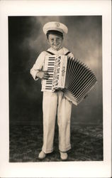 Small boy in uniform playing accordion Postcard