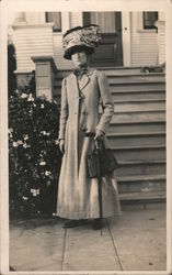 Large Hat: Woman Standing in Front of House Postcard