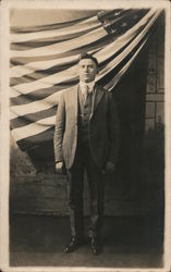 Studio Portrait of man in suit in front of American Flag Postcard