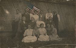 Group of Men and Women Posing with Flag Postcard