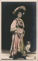 The Milton "Bromette" Series - Lady in long dress and large hat, standing with small dog Postcard