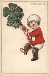 Small child in red-and-white clothes, tall boots, holding giant four-leafed clovers Postcard