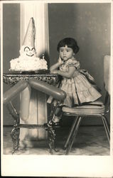 Small girl with clown birthday cake and balloons Postcard