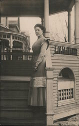 Lena Dixon, standing on porch steps Postcard