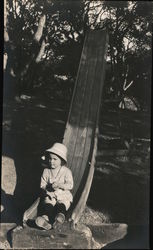 Little child sliding down a slide Postcard