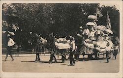 Horses, blankets, pulling a decorated cart full of people with flags and parasols. Postcard