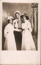 Three young people pose for a picture with American Flags Postcard