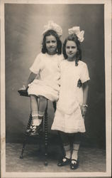 Two girls in white dresses and bows - Tootsie and Sister Rasmussen Crockett - 724 2nd Ave Postcard