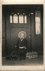 Small child wearing big hat, standing next to toys Postcard