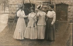 Four women dressed in Victorian clothing Postcard