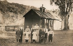 Schoolchildren and Teacher with One Room Schoolhouse Postcard