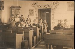 Older students sit in the back of a classroom Postcard