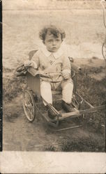 Boy on a Beach in a Stroller Postcard