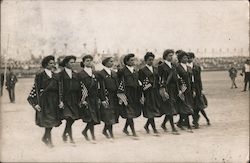 Group of women in uniforms carrying small flags Postcard