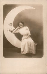 Woman sitting on Paper Moon Moons Postcard Postcard Postcard