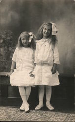 Two Young GIrls Standing With Matching Dresses and Hairbows Postcard