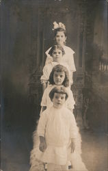 Four children standing and posing Postcard