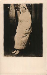 Red Cross Nurse Posing in Front of an American Flag Postcard