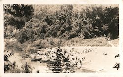 A picture of people leaving canoes on a river Postcard