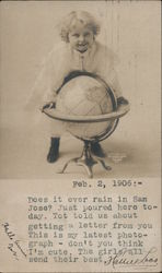 Golden haired child standing over globe in stand Postcard