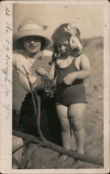 Woman and young child on beach eating grapes Children Postcard Postcard Postcard