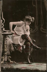 Girl in underthings sitting on arm of chair taking off shoes Risque & Nude Postcard Postcard Postcard