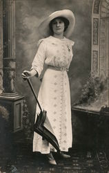 Studio photo of young woman with large hat, umbrella, button shoes Postcard