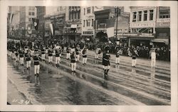 Band playing and marching down street Postcard