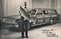 Harold Ensley, station wagon with logos Ford Show. Harold holding large fish. Signed Celebrities Postcard Postcard Postcard