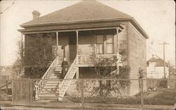 Woman in black dress on steps of two story house Sacramento, CA Postcard Postcard Postcard