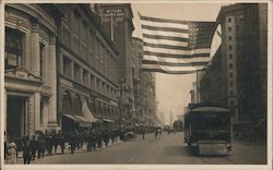 San Francisco downtown street scene with flag and streetcar, early 20th century Postcard