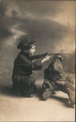 Studio photo of little soldier boy shooting toy gun braced on log Children Postcard Postcard Postcard