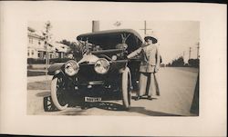 Woman standing next to convertible Car, large headlights, license 80374 Cars Postcard Postcard Postcard