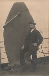 Man posing on ship with equipment Postcard