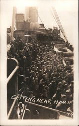 Getting Near Home. Service men crowd deck of ship, life rafts Postcard